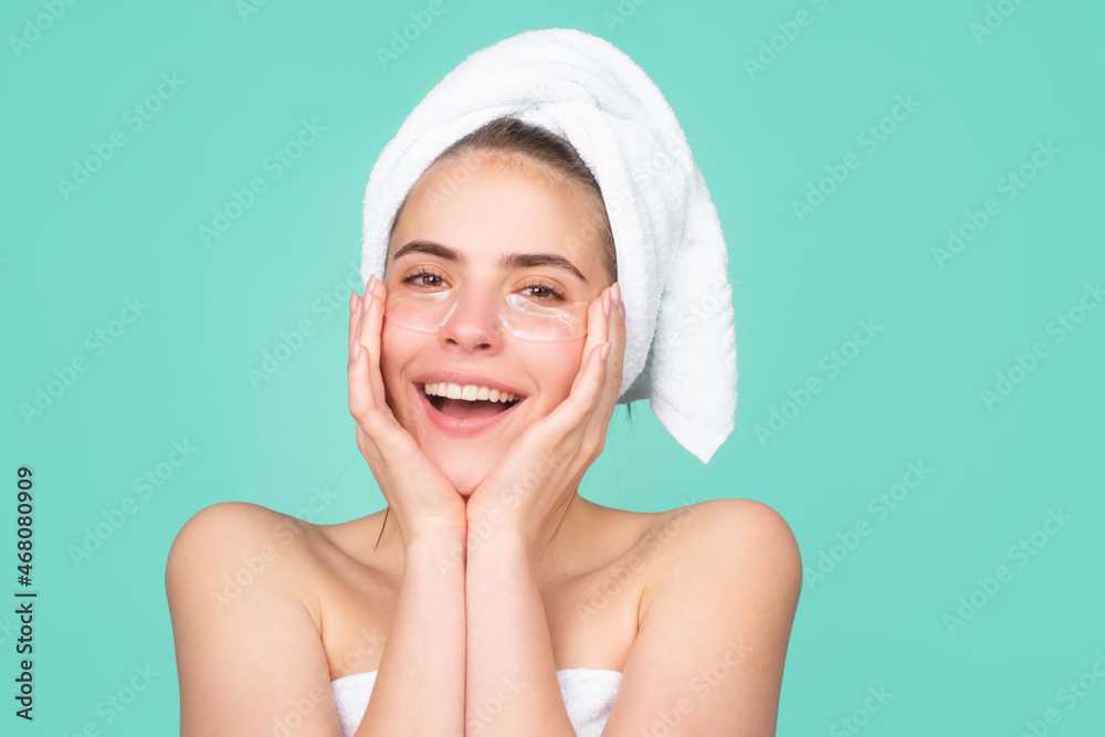 Smiling woman with a facial mask. Charming pretty model after bath wrapped in towel applying using face mask, sensual face. Moisturizer on skin, cream face. Smiling woman with a facial mask. Charming pretty model after bath wrapped in towel applying using face mask, sensual face. Moisturizer on skin, cream face.