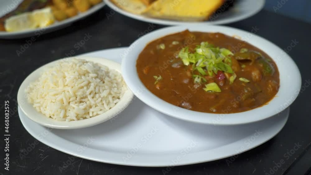 Restaurant plating of traditional Cajun Gumbo and white rice, slider HD Restaurant plating of traditional Cajun Gumbo and white rice, slider HD