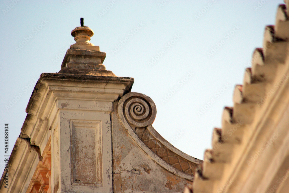 A close up view of facade and curvy roof details of a portuguese house