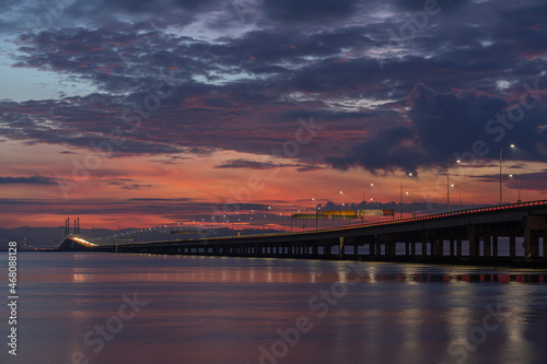 Burning sunrise over the bridge. © Khor