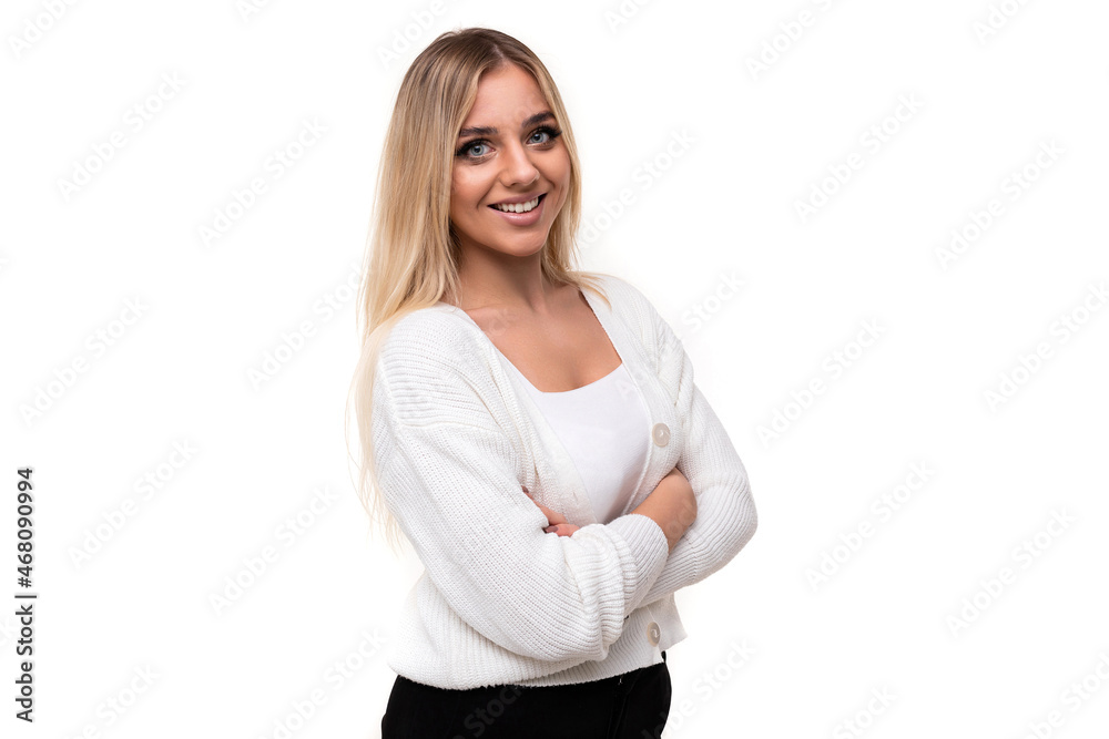 Photo of a beautiful pretty amazing positive smiling happy young blonde woman with makeup in a stylish white knitted sweater and black pants isolated on a white background with copy space for text Photo of a beautiful pretty amazing positive smiling happy young blonde woman with makeup in a stylish white knitted sweater and black pants isolated on a white background with copy space for text