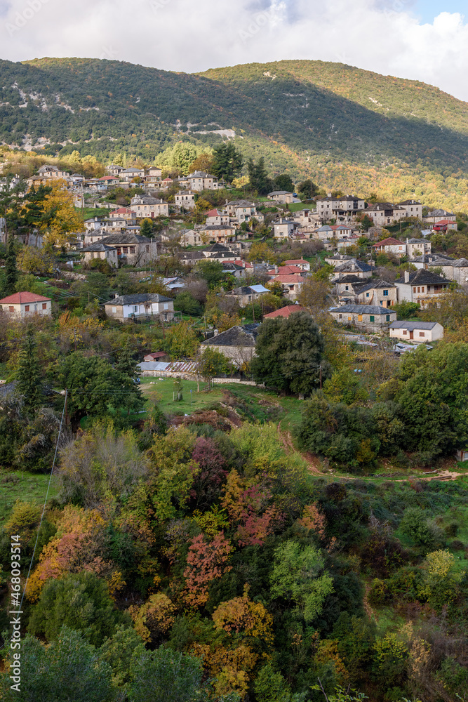 Fototapeta premium Panorama view of village Aristi with Picuresque stone buildings during fall season in Zagori Greece.