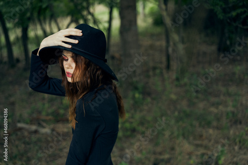 woman witch in black hat in the forest posing fantasy © VICHIZH