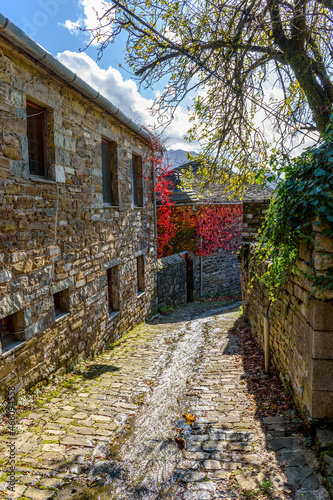 Traditional architecture  with  a narrow road and stone buildings  during  fall season in the picturesque village of papigo   zagori Greece