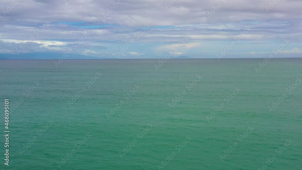 Open blue ocean with waves against the sky and clouds, aerial view. Summer and travel vacation concept Open blue ocean with waves against the sky and clouds, aerial view. Summer and travel vacation concept