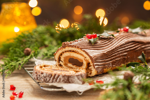 Traditional Christmas cake, chocolate Yule log with festive decorations 