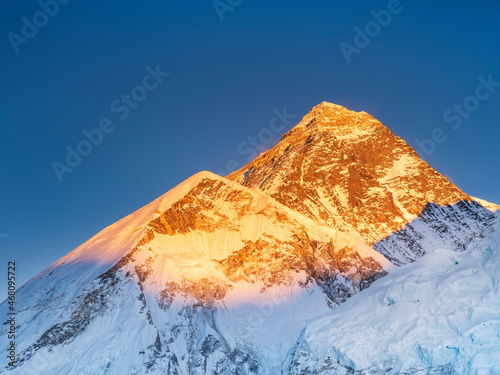 peaks Everest and Nuptse in last sun lights under blue sky with copy space in giant resolution