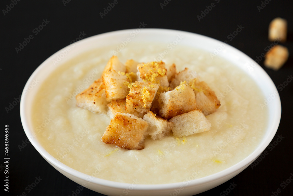 Homemade Cauliflower Soup with Croutons and Oil, side view. Close-up. Homemade Cauliflower Soup with Croutons and Oil, side view. Close-up.