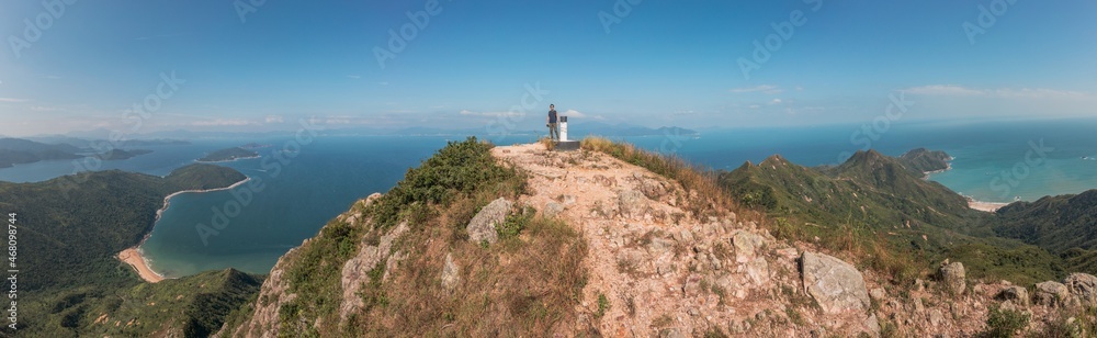Amazing panorama of Man standing of Sharp Peak, Sai Kung, Hong Kong.