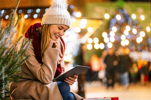 Festive christmas fair concept. Happy smiling woman having fun and shopping on the christmas market.