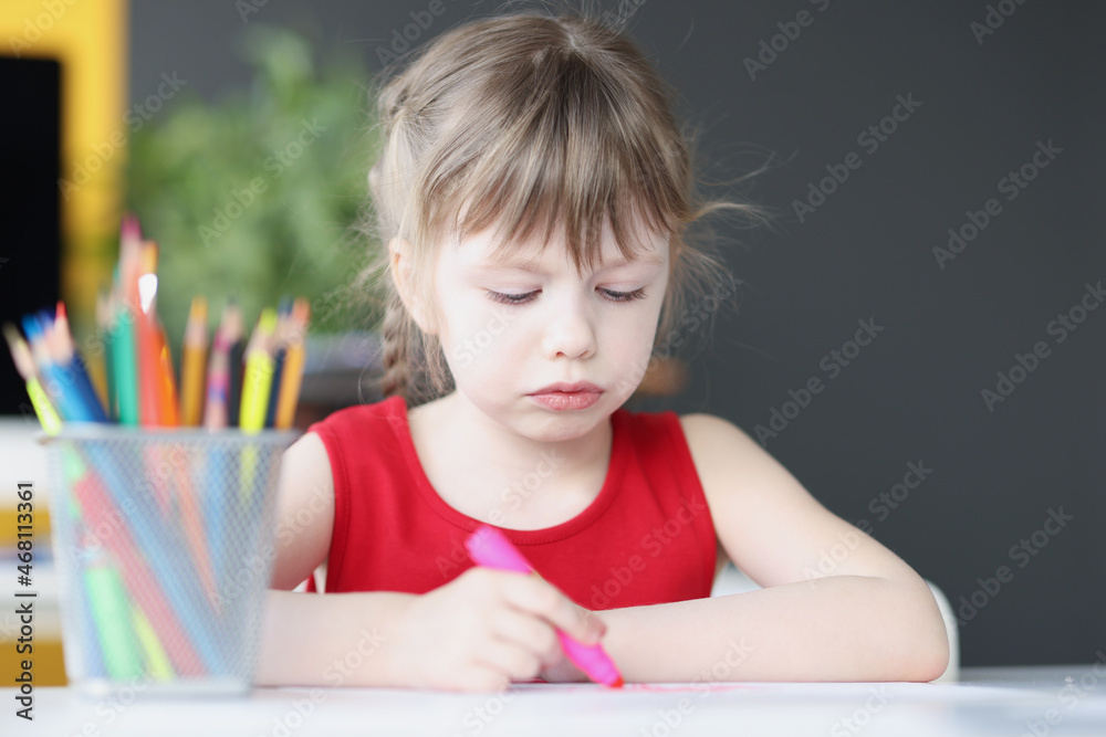 Little girl drawing at table with colored pencils Little girl drawing at table with colored pencils