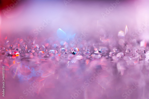 Pink abstract photography, shiny, bling effect, bokeh. Water droplets on blue background for overlay or montage, copy space with place for text. Soft, out of focus image.