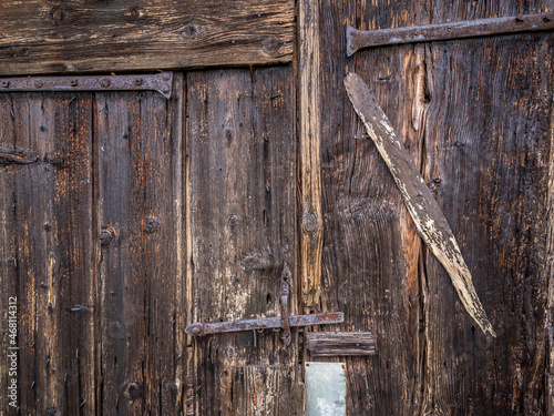 Closing details of an old wooden barn door