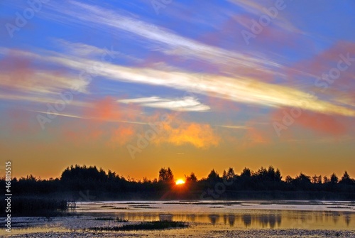 sanrise and beautiful clouds over the lake photo