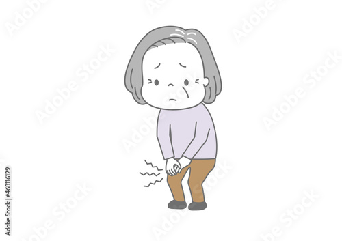 ひざが痛い　痛む膝を押さえて辛そうな顔をしている高齢女性