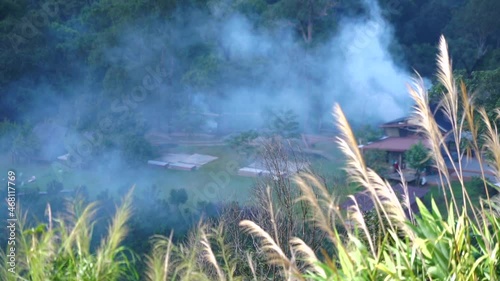 View of the hills and man made a fire and smokes on the air, At monjam Chiang mai Thailand. photo