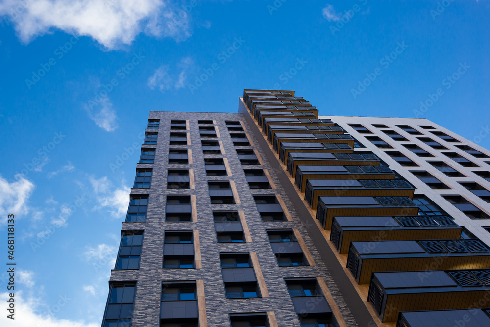 modern multistory building with blue sky and clouds background modern multistory building with blue sky and clouds background