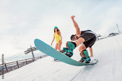 Young couple snowboarders having fun at ski resort
