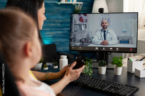 Family waiting medical advice from remote therapist doctor discussing sickness diagnostic during online videocall meeting conference. Teleconference call on computer . Distance telework consultation