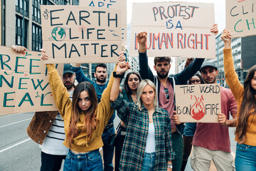 fridays for future crowd protesting on the street with banners against pollution and global warming