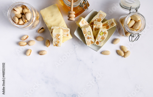 White chocolate covered nougat. Nougat with pistachios and almonds. These delicious confections are filled with the dried almonds and pistachio nuts and covered with white chocolate.