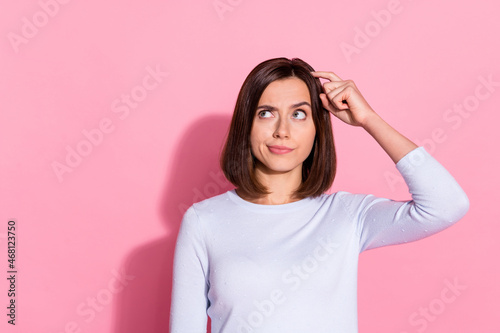 Photo of unsure thoughtful young woman wear white sweater finger head forget important thing isolated pink color background