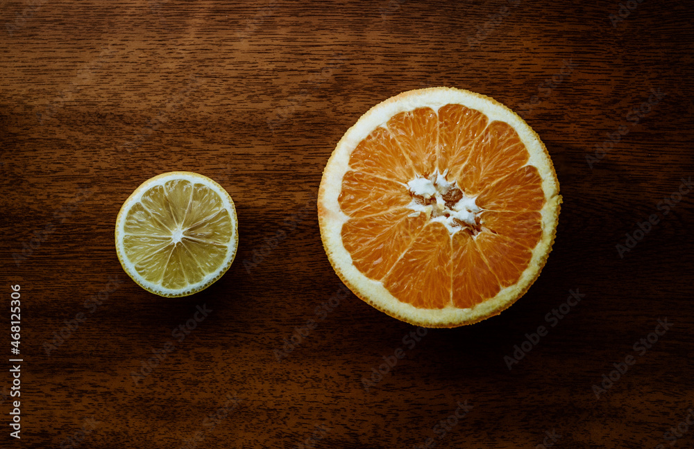 Citrus vitamins. half of lemon and orange lies on Citrus vitamins. half of lemon and orange lies on