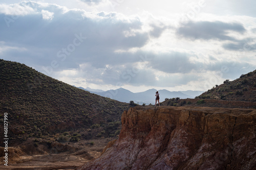 Adventurous young girl taking pictures in the mountains of the Mazarron desert