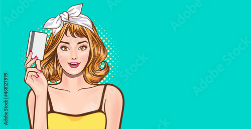 smiling beautiful woman presenting credit card in hand showing