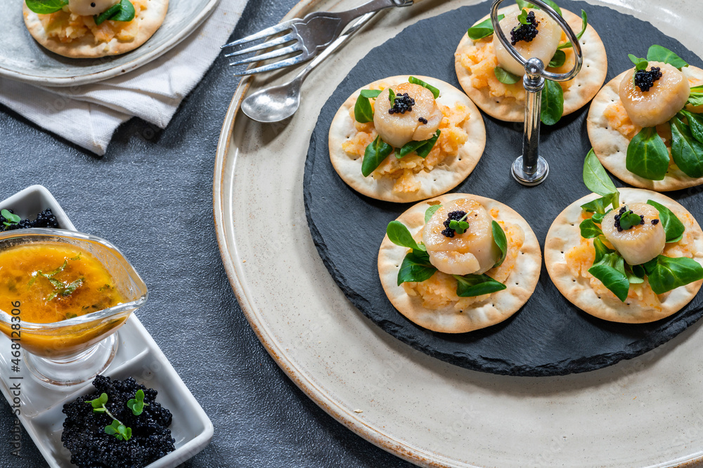 Canapes with scallops, caviar and lime and butter sauce Canapes with scallops, caviar and lime and butter sauce