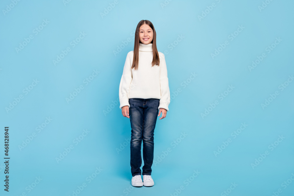 Photo of pretty shiny student girl wear white sweater smiling walking isolated blue color background Photo of pretty shiny student girl wear white sweater smiling walking isolated blue color background