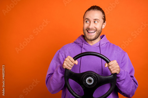 Photo of funky millennial brown tail hairdo guy look promo drive wear purple sweatshirt isolated on orange color background