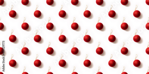 Seamless pattern with red and golden Christmas toy balls on a white background. Christmas texture. Holiday design mockup concept. Poster wallpaper. Festive banner. Template. New year greeting card