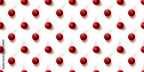Seamless pattern with red and golden Christmas toy balls on a white background. Christmas texture. Holiday design mockup concept. Poster wallpaper. Festive banner. Template. New year greeting card