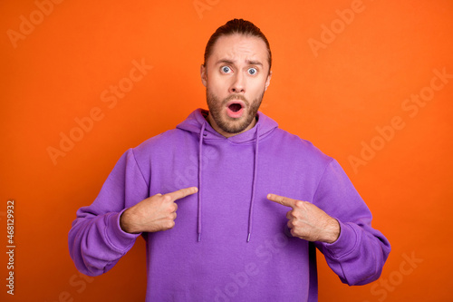 Photo of impressed millennial brown tail hairdo guy index himself wear purple hoodie isolated on orange color background photo