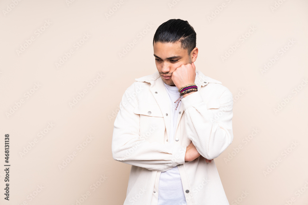 Asian handsome man over isolated background with tired and bored expression Asian handsome man over isolated background with tired and bored expression