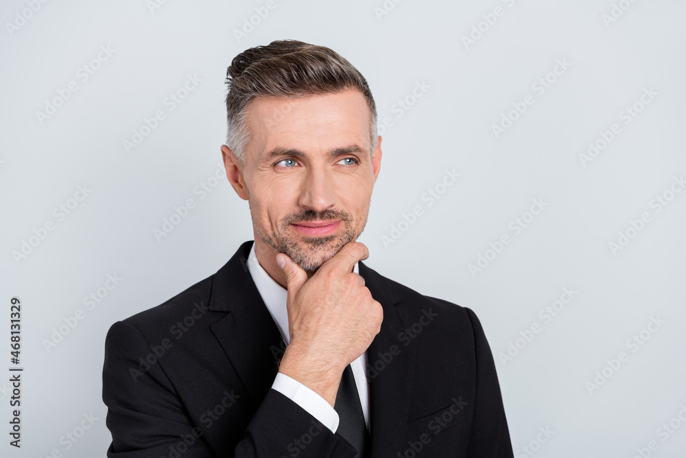 Photo of thoughtful positive mature clerk dressed arm chin looking empty space isolated grey color background Photo of thoughtful positive mature clerk dressed arm chin looking empty space isolated grey color background