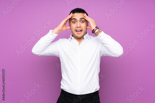 Asian handsome man isolated on blue background with surprise expression