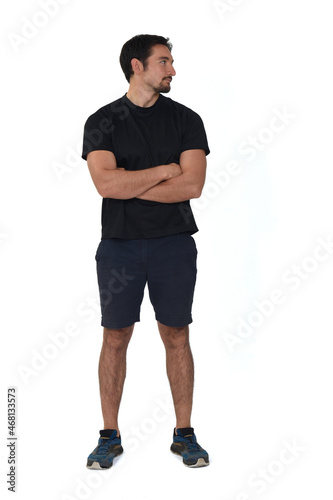 front view of man wearing sportswear, shorts, looking side isolated on white background