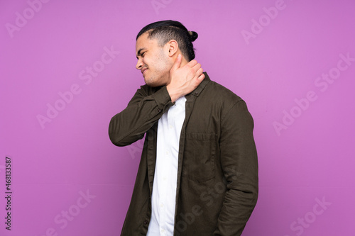 Asian handsome man isolated on blue background with neckache