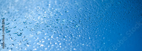Closeup blue rain water drops shallow depth of field