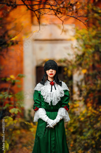 Woman in vintage costume in autumn forest