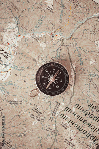 Black compass on routes on the world map discovery, navigation, communication, logistics, geography, transportation and travel theme concept background © Shi 