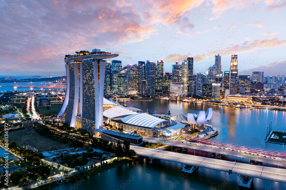 View from above, stunning aerial view of the Singapore skyline with the financial district in the distance during a beautiful sunset. Singapore.