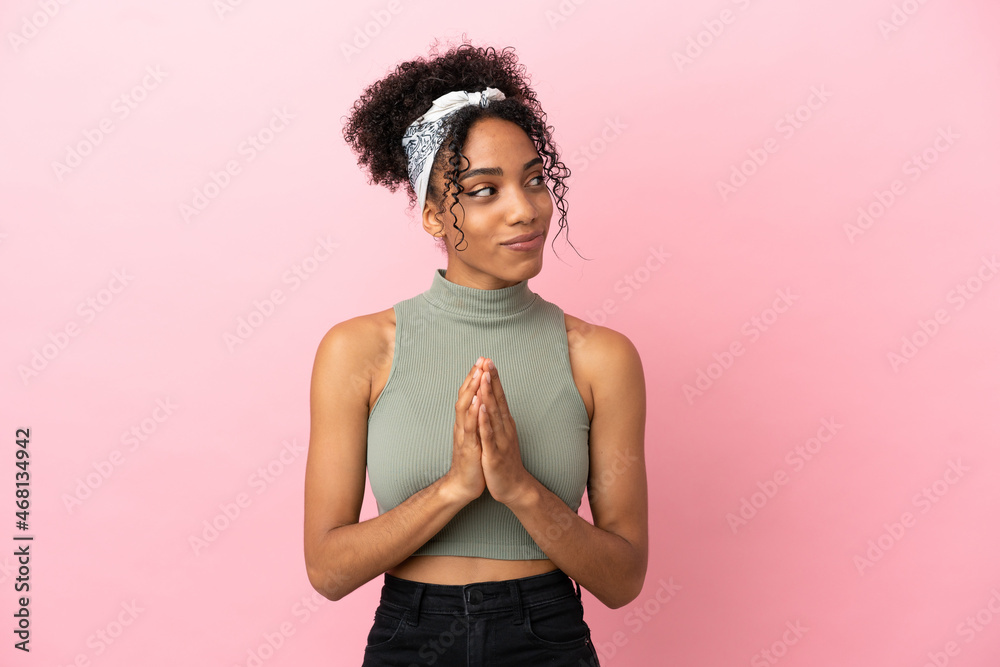 Young latin woman isolated on pink background scheming something