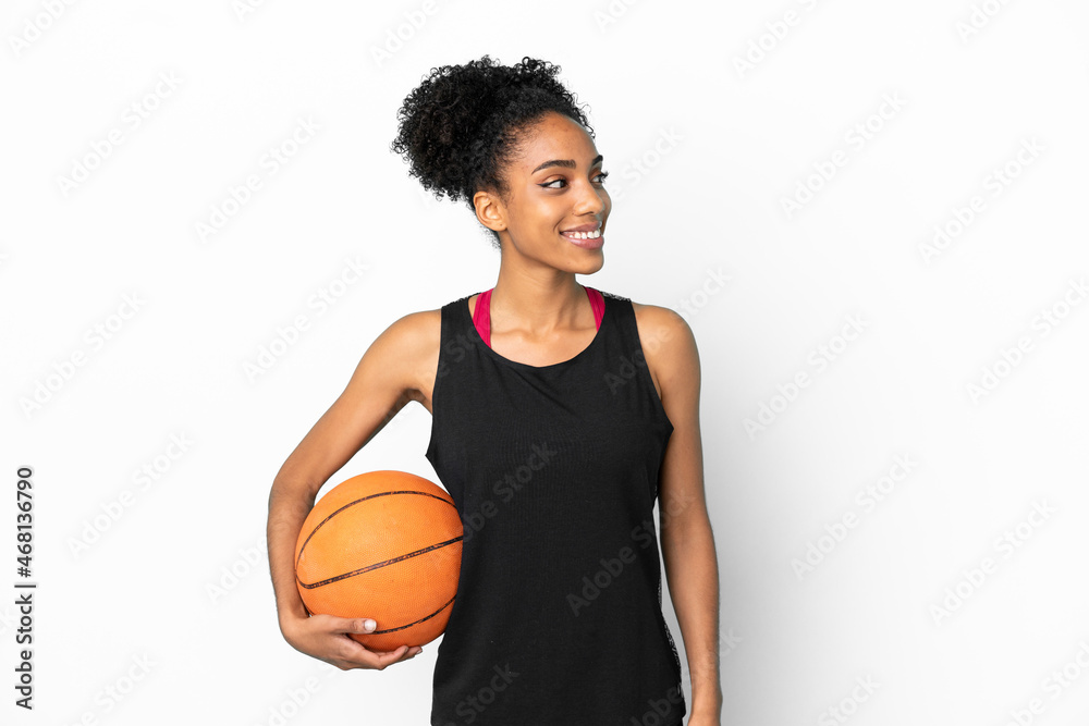 Young basketball player latin woman isolated on white background looking side