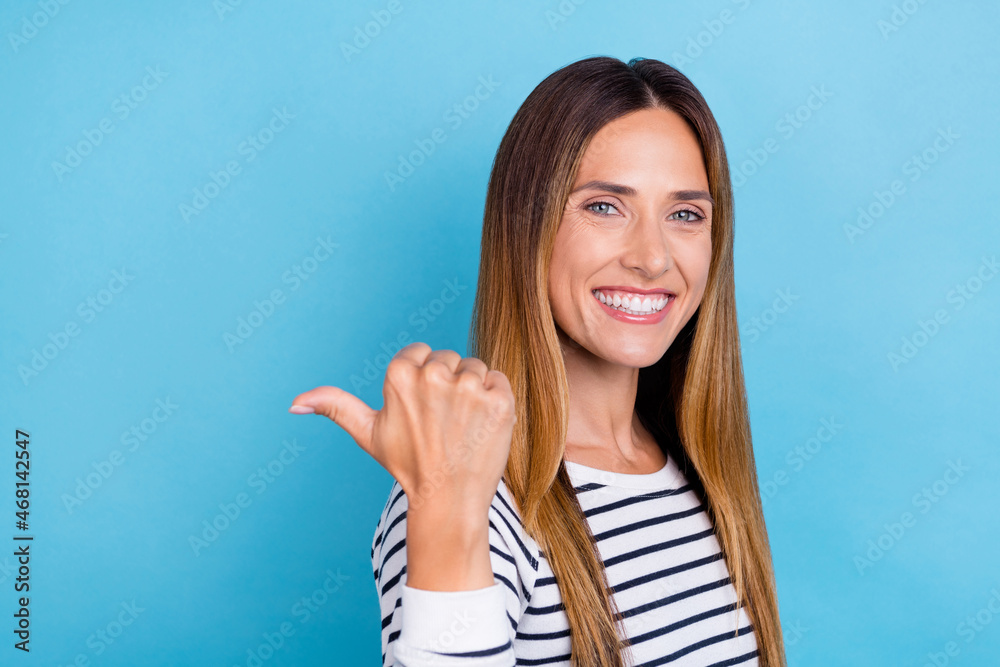 Profile photo of mature blond optimistic lady point empty space wear striped shirt isolated on blue color background Profile photo of mature blond optimistic lady point empty space wear striped shirt isolated on blue color background