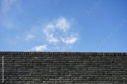 Photos City wall, brick wall, blue sky and white clouds