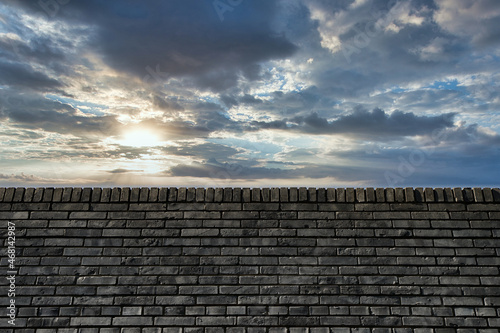 Quadro su tela City wall, brick wall, blue sky and white clouds