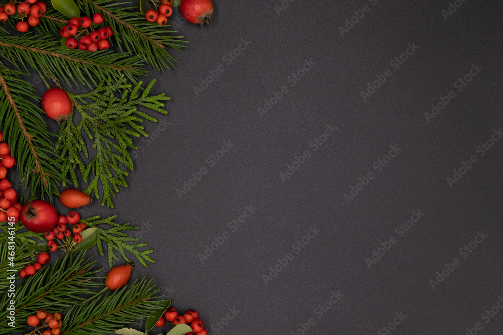 Christmas background of pine branches decorated with red toys and berries, new year concept, flat lay, top view